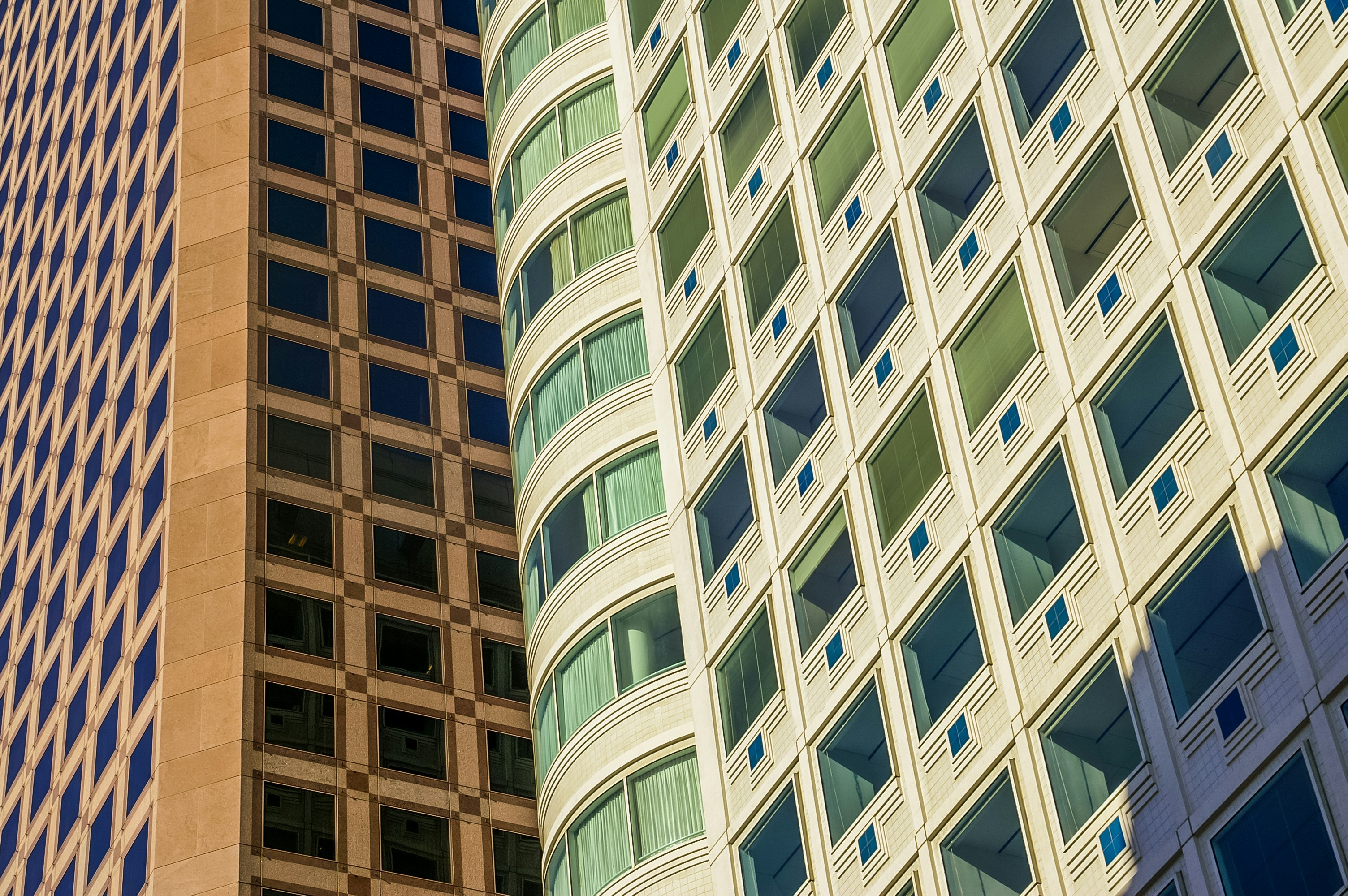 low angle photo of curtain glass wall buildings